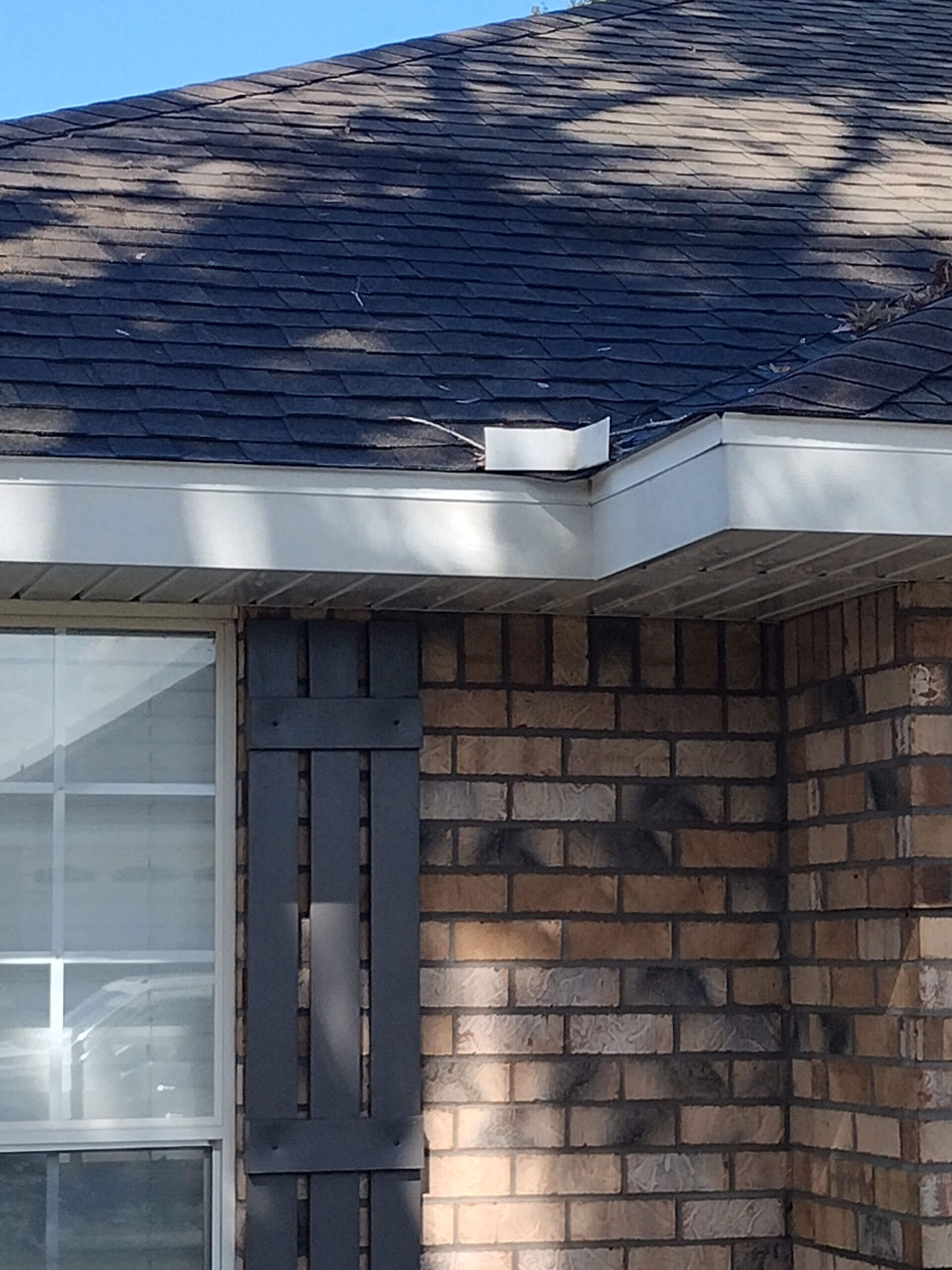 Close-up of a residential roof with dark asphalt shingles